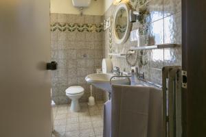 a bathroom with a sink and a toilet at Albergo Il Cochino in Montale +74 photos