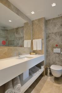a bathroom with a sink and a toilet at Lugga Boutique Hotel & Beach in Ortakent