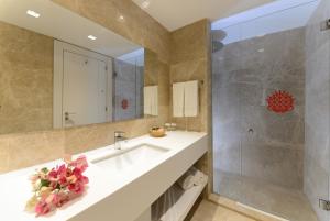 a bathroom with a sink and a shower at Lugga Boutique Hotel & Beach in Ortakent