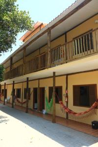 a building with hammocks on the side of it at Chili In Suites Maresias in Maresias