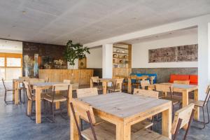 a dining room with wooden tables and chairs at Aquiles Eco Hotel in São Pedro