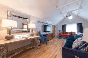 a living room with a blue couch and a mirror at Suites at number Ten in Broadstairs