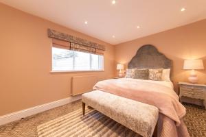 a bedroom with a large bed and a window at Suites at number Ten in Broadstairs