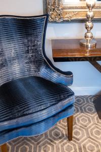 a black chair sitting next to a table at Suites at number Ten in Broadstairs