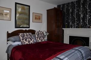 a bedroom with a bed and a fireplace at Averon House in Inverness