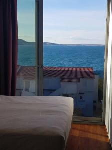 a bedroom with a bed and a view of the ocean at Bara Bay in Metajna