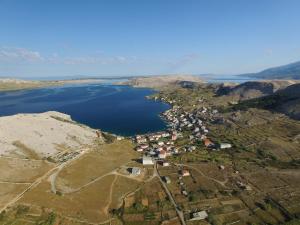 an aerial view of a lake in the mountains at Bara Bay in Metajna