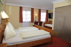 Ένα ή περισσότερα κρεβάτια σε δωμάτιο στο Hotel Gasthof Kamml