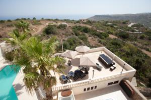 an aerial view of a house with a palm tree at Villa Bernardette in Xagħra