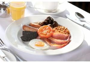 a plate of breakfast food on a table at London Chigwell Prince Regent Hotel, BW Signature Collection in London