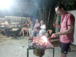 a man is lighting a fire on a grill at Sunny Side 89 in Galle