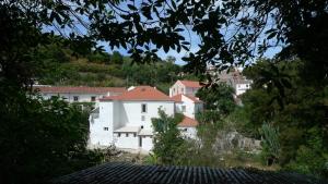 a group of white buildings on a hill at ribeira dos marinheiros amarelo in Sintra