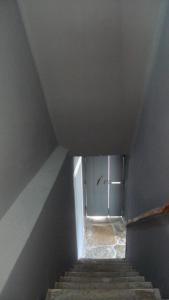 a stairway with a door in a room with stairs at ribeira dos marinheiros amarelo in Sintra