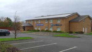 a building with a parking lot in front of it at Eyesleepover in Eyemouth