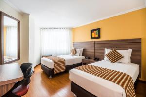 Una cama o camas en una habitación de Hotel San Pablo