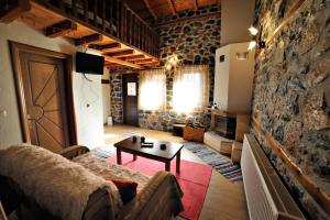 ein Wohnzimmer mit einem Sofa und einem Tisch in der Unterkunft Aroma Elatis in Palaios Agios Athanasios