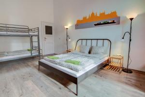 a bedroom with a bed and two bunk beds at Pal's Mini Hostel in Budapest