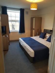 um quarto com uma cama grande e uma janela em Braganza House em Portsmouth