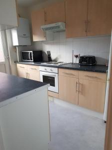 a kitchen with a stove and a microwave at Braganza House in Portsmouth