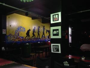 a room with a wall with a painting of dancers on it at Trevo Parque Hotel in São Sepé