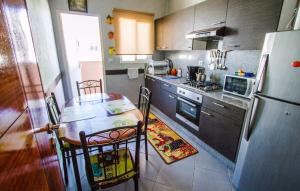 a kitchen with a table and a refrigerator at Salam Appartement Agadir in Agadir