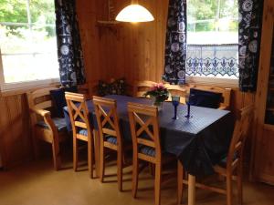 a dining room with a blue table and chairs at Villa Blau am Useriner See mit Garten in Userin