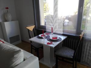 a living room with a white table with two candles on it at Lotus in Trier