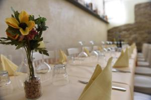 a dining room table filled with white flowers at Il FEUDO in San Gimignano