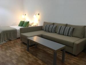 a living room with a couch and a coffee table at Estudios Ciudad Jardín in Las Palmas de Gran Canaria