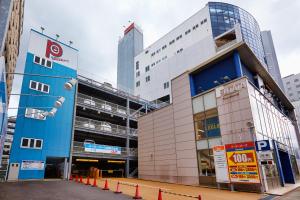 a large building with orange cones in front of it at S Peria Hotel Nagasaki in Nagasaki