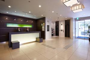 two men sitting at a reception desk in a lobby at S Peria Hotel Nagasaki in Nagasaki