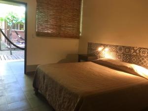 Ένα ή περισσότερα κρεβάτια σε δωμάτιο στο Hotel & Bar La Guitarra +30 φωτογραφίες