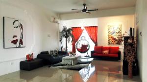 a living room with couches and a ceiling fan at Mahkota Cheras Sweet Condo 1-14 pax near MRT to KL in Kuala Lumpur