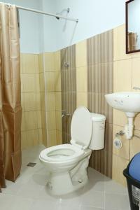 a bathroom with a toilet and a sink at Global 88 Apartelle in Cebu City