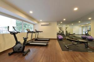 a gym with several treadmills and exercise bikes at Studio Residence Sukhumvit 71 in Bangkok