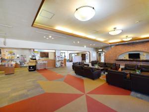 a waiting room with couches and chairs in a store at Hotel Wellness Notoji in Hakui