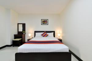 a bedroom with a large bed and two night stands at Studio Residence Sukhumvit 71 in Bangkok
