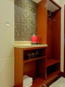 a small bathroom with a sink and a shower at Qingdao Hua Qi Kaiserdom Hotel in Qingdao