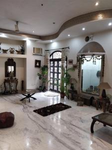 a large living room with a large marble floor at Khanna House in Kolkata