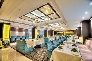 a restaurant with tables and chairs and a large window at Best Western Summerlea jalandhar in Jalandhar