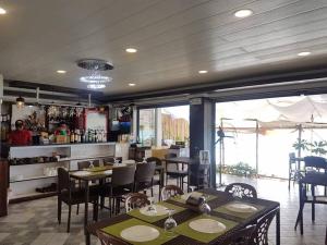 a restaurant with tables and chairs and a bar at Diamond Water Edge Resort in Boracay