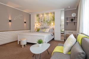 1 dormitorio con cama, sofá y mesa en Villa-Meehr, en Bantikow