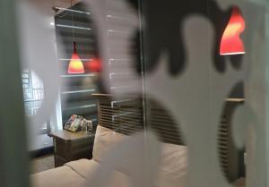 a room with a couch and a table and a mirror at Hôtel Henri IV in Nérac