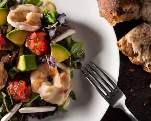 a plate of shrimp salad with a fork and bread at Transit Motel Ukonga in Dar es Salaam