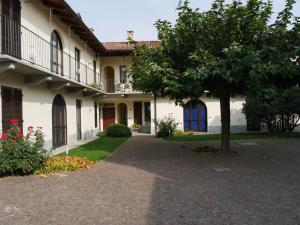 um edifício com uma árvore no meio de uma entrada em La Maison du Soleil Appartamento Alba Pompeia em Alba