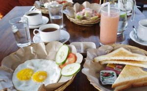 a table with eggs and bread and toast and drinks at Transit Airport B&B in Dar es Salaam