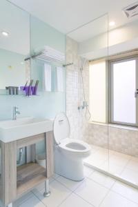 a bathroom with a toilet and a sink at RF Hotel - Sanchong in Taipei +40 photos