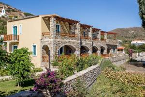 a large stone house with a stone wall at Anemoessa Luxury Villas in Fanari