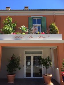 a building with a sign that reads hotel ice home at Hôtel La Flore in Villefranche-sur-Mer