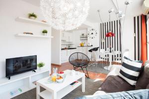 a living room with a couch and a table at SingularStays Botanico29 in Valencia